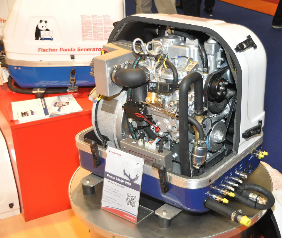 Compact marine generator displayed with its enclosure open, showing the engine, hoses and connections